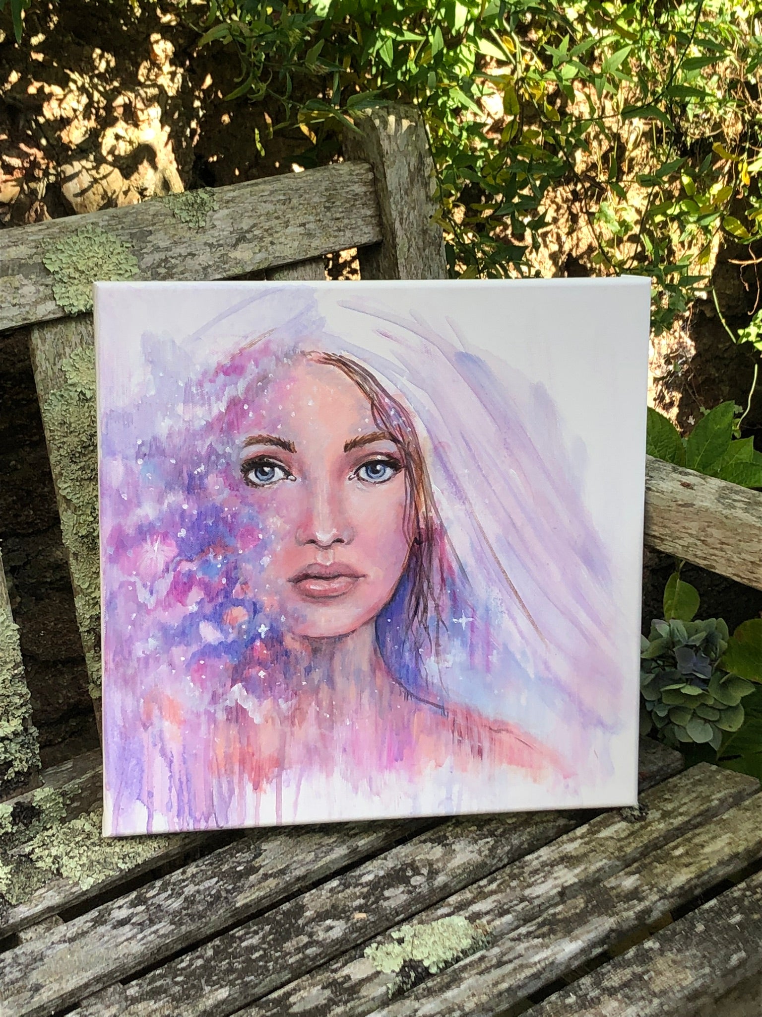 Between Worlds original painting by Julie Hogarth-Jones photographed outdoors on a bench.