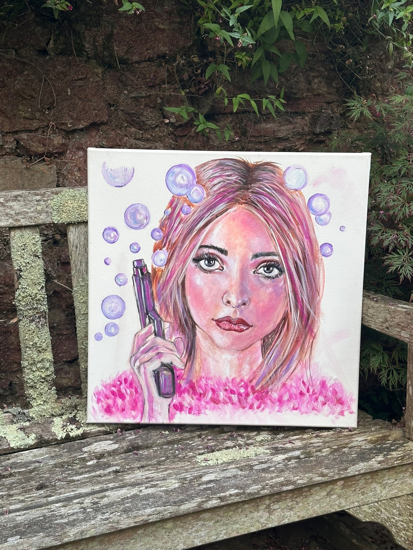 Bubbling - original painting by Julie Hogarth-Jones. Woman holding a gun emitting purple bubbles styled on a bench outside.