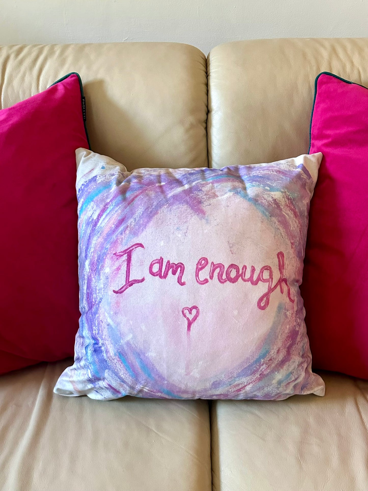 I Am Enough cushion by Julie Hogarth-Jones - soft graffiti word art on a cushion styled on a sofa