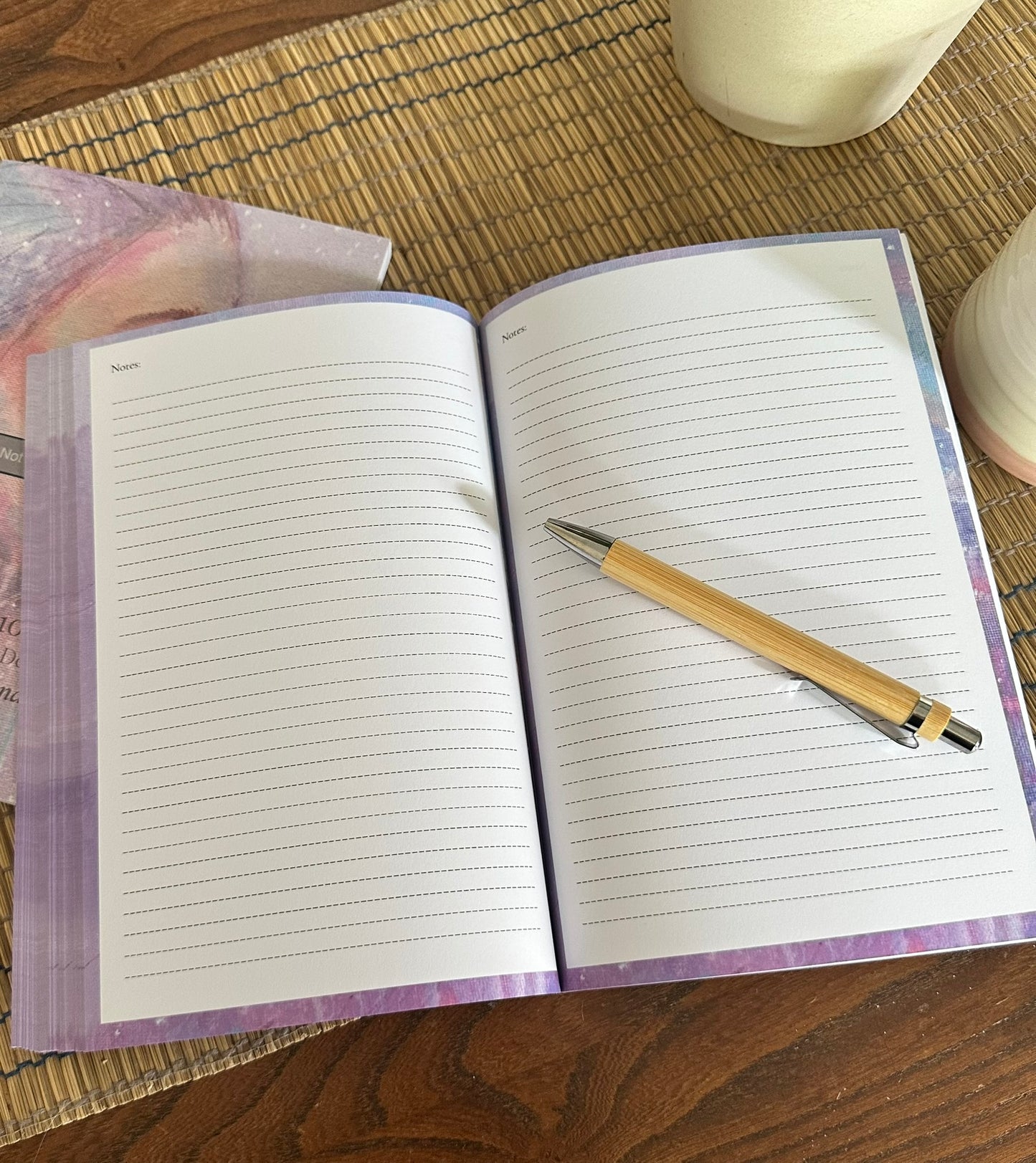 Interior of the Into the Wild bucket list book by Julie Hogarth-Jones - blank pages open ready to writ, styled with a pen.