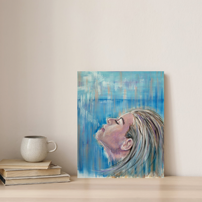 Siren Song canvas print by Julie Hogarth_Jones  portrait of a woman with long hair against a blue abstract background displayed on a shelf in a styled home setting. 