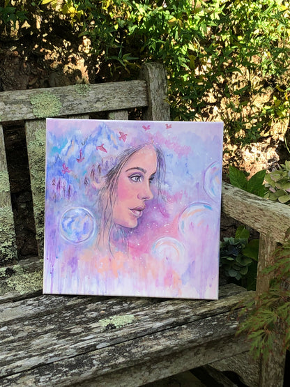 The Space Between original painting by Julie Hogarth-Jones photographed on a bench outside.