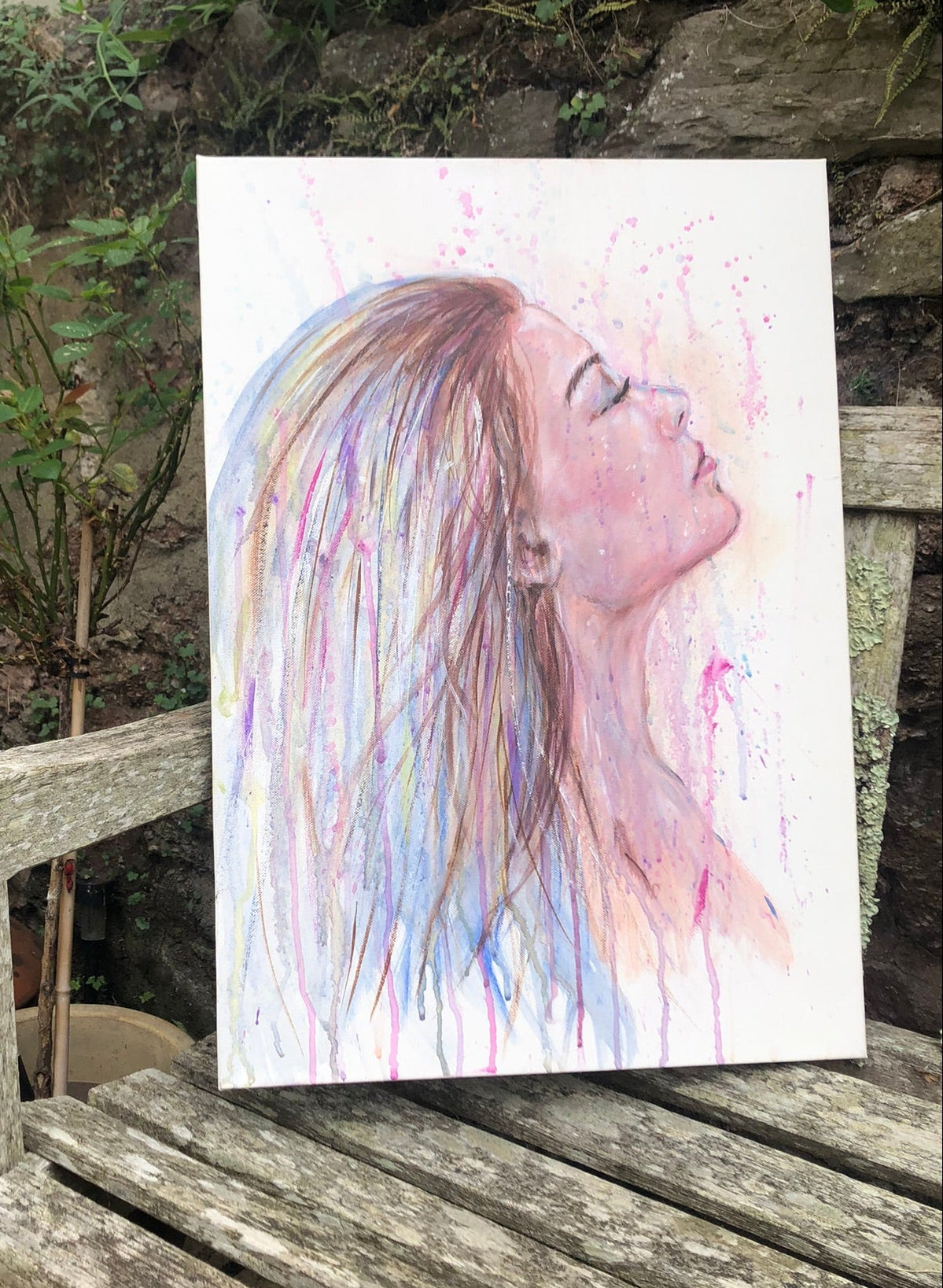 Wash Away My Fears original painting by Julie Hogarth-Jones photographed on a bench outside.